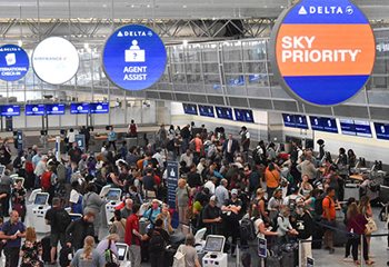 Hundreds of people check in at kiosks and with agents before they go through security in Terminal 1.