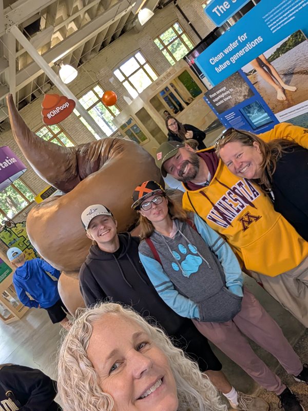 Family and friends take a selfie in the Oh poop! exhibit.