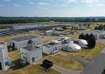Aerial view of the facility, showing buildings and aeration tanks.